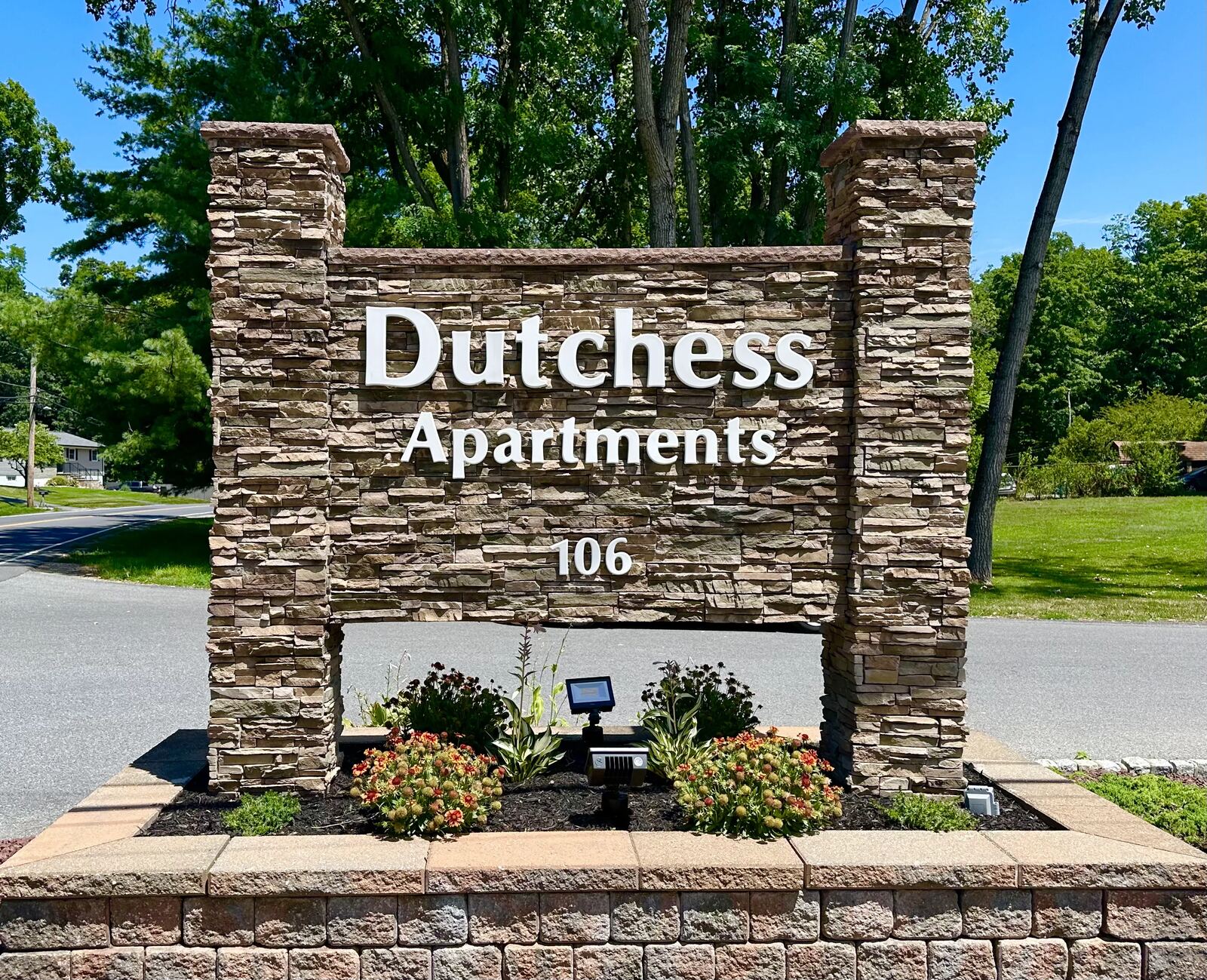 The stone entrance sign at Dutchess Apartments